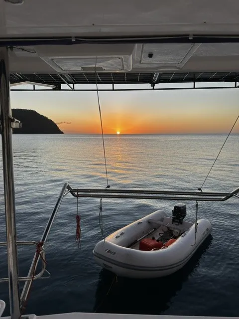 Sunset over the anchorage, dinghy hanging from the davits
