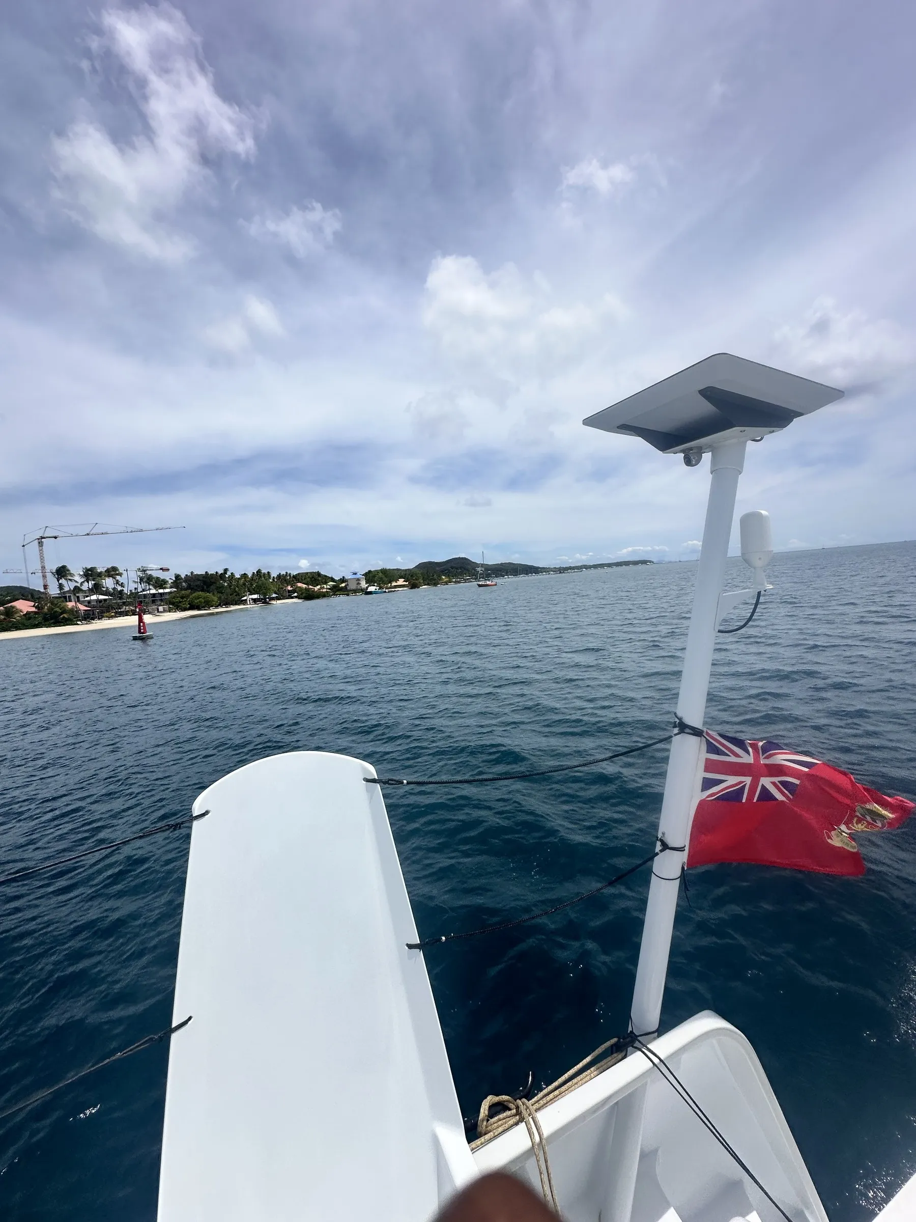 Red ensign flying off the stern, heading out along the coast