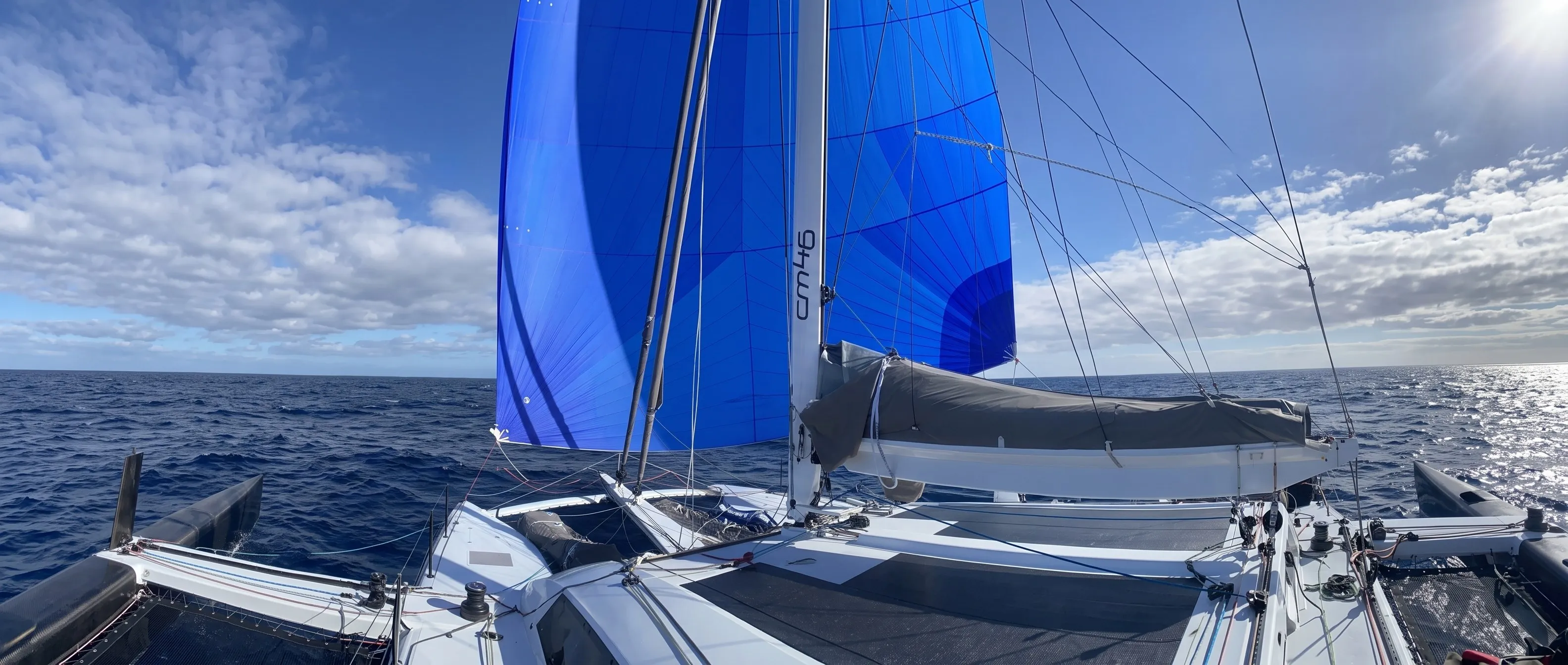 Catamaran flying a blue spinnaker across the Caribbean